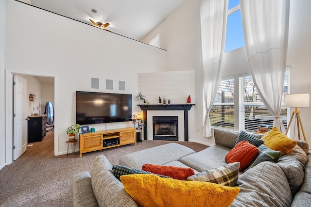 living area with high vaulted ceiling, carpet, a fireplace, and baseboards