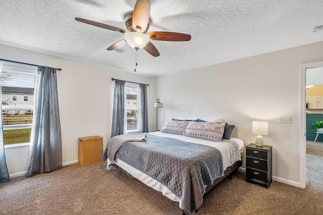 carpeted bedroom with ceiling fan, a textured ceiling, and baseboards