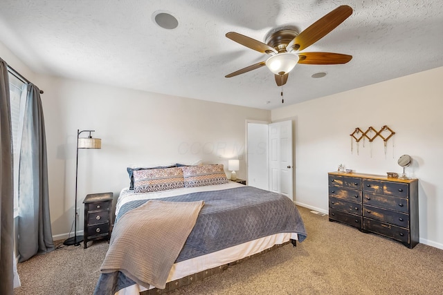 bedroom featuring a textured ceiling, ceiling fan, visible vents, baseboards, and carpet