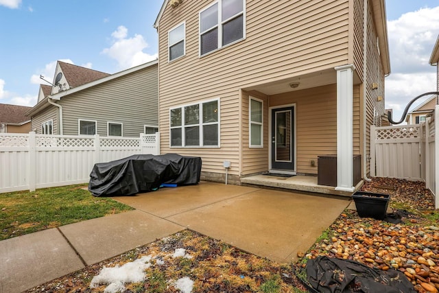 rear view of property featuring fence and a patio