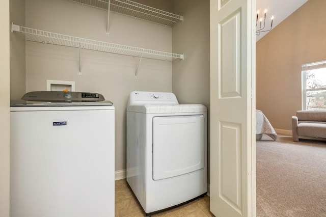 laundry room featuring laundry area, light colored carpet, baseboards, and washing machine and clothes dryer