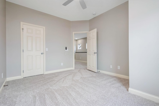 unfurnished bedroom with baseboards, ceiling fan, and light colored carpet