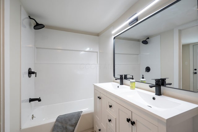 bathroom featuring a sink, bathtub / shower combination, and double vanity