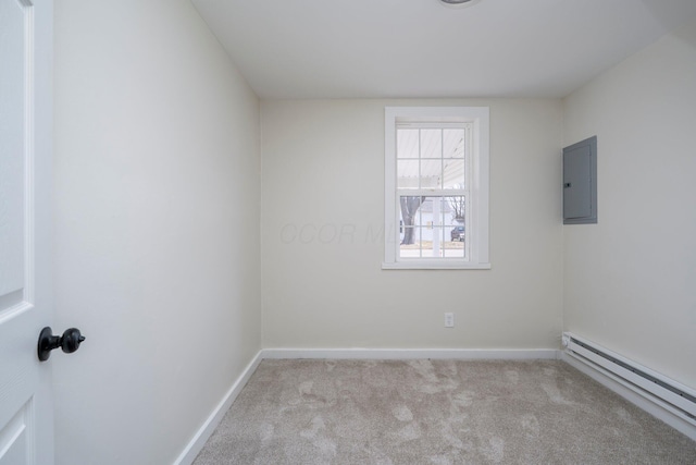 spare room featuring electric panel, baseboards, carpet floors, and a baseboard radiator