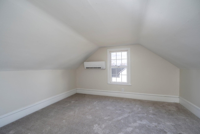 bonus room with a wall unit AC, carpet flooring, and vaulted ceiling