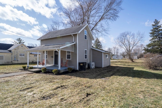 view of front of property with covered porch, a front lawn, and ac unit