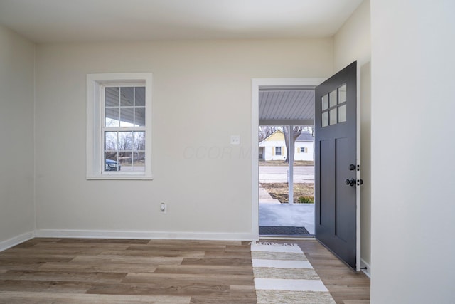 entrance foyer featuring light wood-style flooring and baseboards