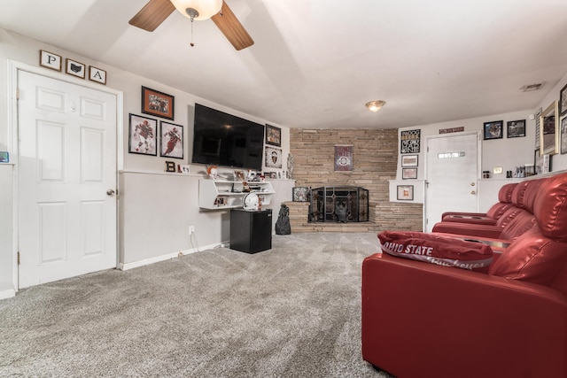 living room featuring ceiling fan, a fireplace, visible vents, baseboards, and carpet