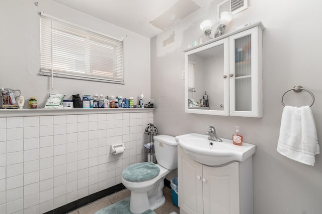 bathroom with vanity, toilet, and tile patterned floors