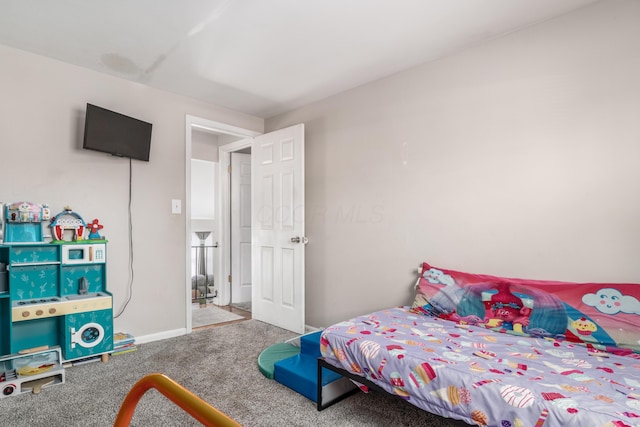 bedroom featuring carpet floors and baseboards