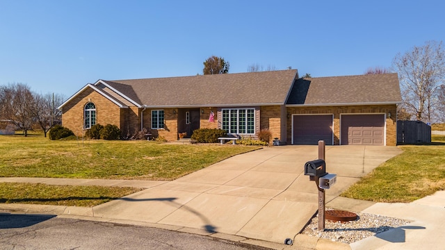 ranch-style home featuring a garage, brick siding, driveway, and a front yard