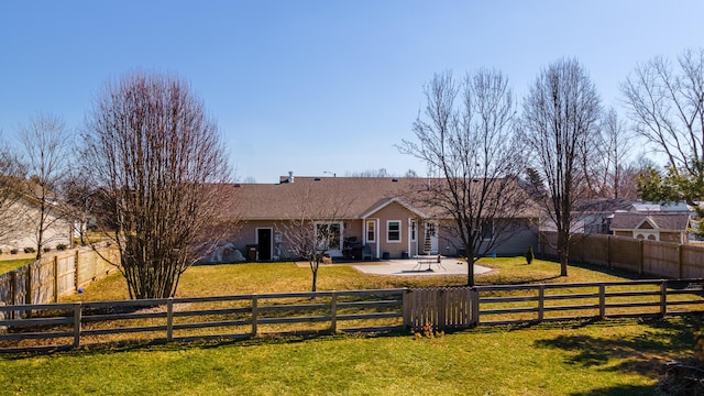 view of front of house featuring a shingled roof, a fenced backyard, a patio, and a front lawn