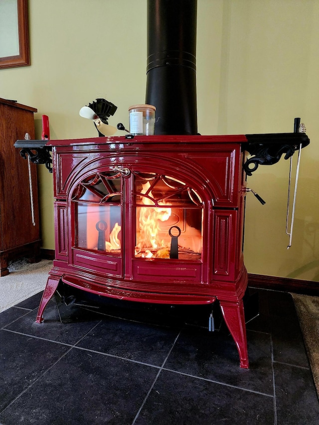 interior details featuring a wood stove and baseboards