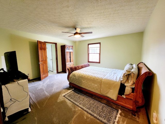 bedroom with ceiling fan, baseboards, a textured ceiling, and light colored carpet