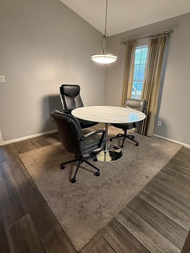 dining room with baseboards, vaulted ceiling, and wood finished floors