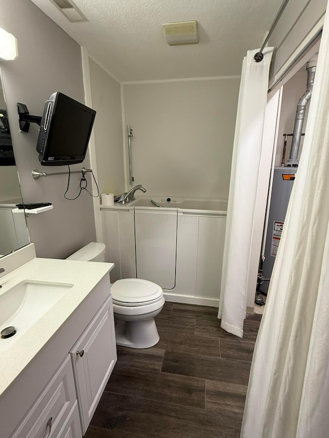 bathroom featuring visible vents, toilet, wood finished floors, a textured ceiling, and water heater