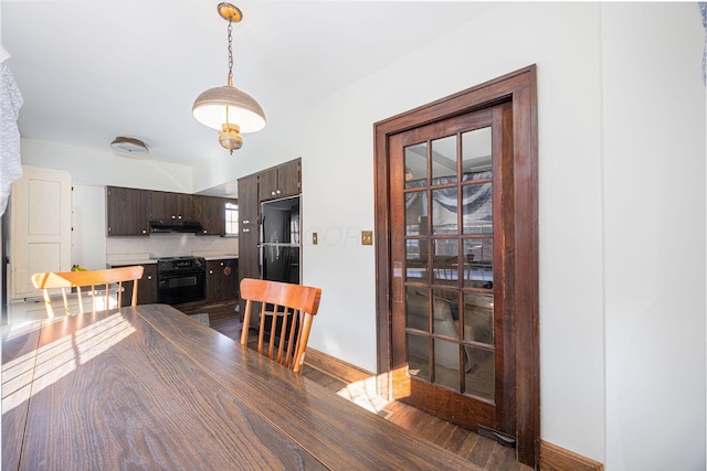 dining space featuring baseboards and wood finished floors