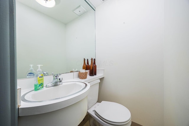 bathroom with visible vents, vanity, and toilet