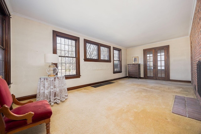 living area with carpet floors, french doors, visible vents, and ornamental molding