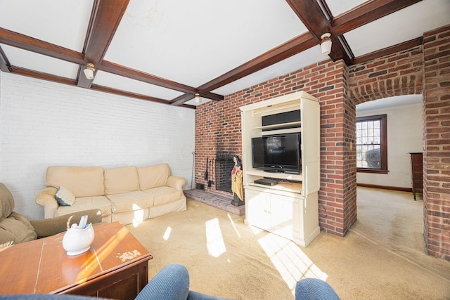 living room featuring brick wall, coffered ceiling, and a fireplace