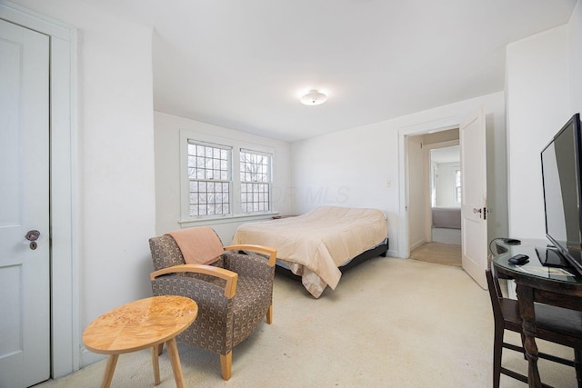 bedroom featuring light colored carpet