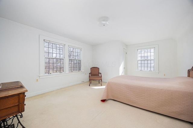 bedroom featuring carpet and baseboards