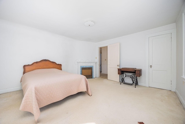 bedroom with baseboards and light colored carpet