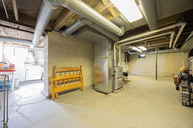 unfinished basement with heating unit and washing machine and dryer