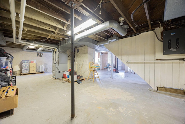 basement with electric panel and heating unit