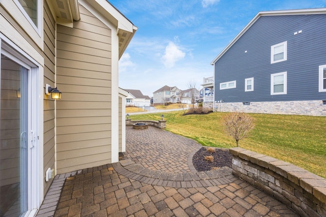 view of patio featuring a residential view and an outdoor fire pit