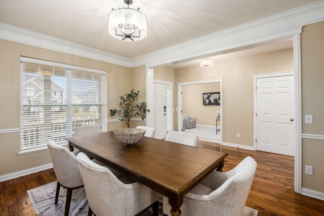 dining area featuring baseboards, a chandelier, and dark wood finished floors