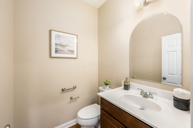 bathroom featuring toilet and vanity