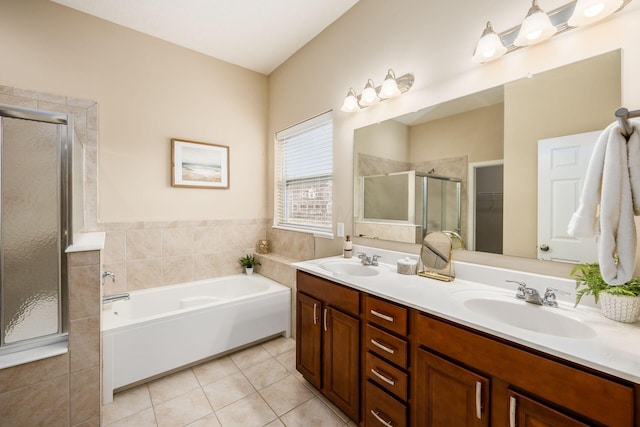 full bath featuring a stall shower, a sink, and tile patterned floors