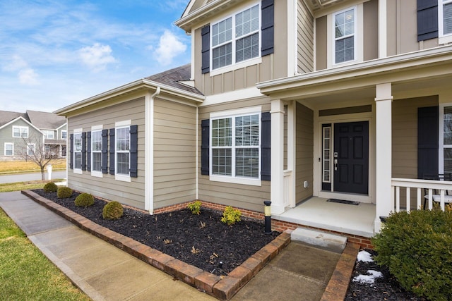 doorway to property featuring board and batten siding