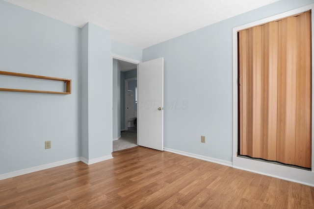 unfurnished bedroom featuring baseboards and light wood finished floors