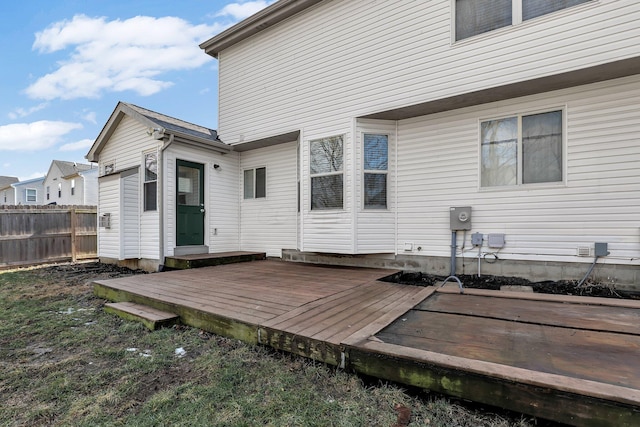 back of house featuring a deck and fence