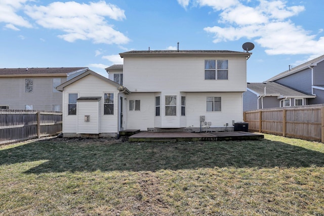 back of property featuring a deck, a yard, a fenced backyard, and central air condition unit