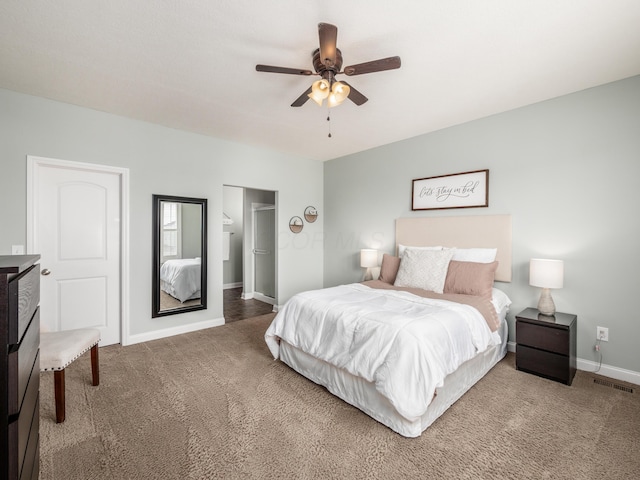 carpeted bedroom featuring baseboards, visible vents, a ceiling fan, a spacious closet, and a closet