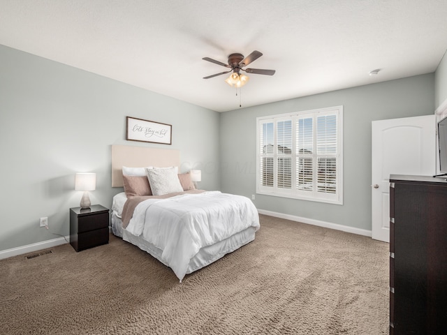 bedroom with ceiling fan, carpet flooring, visible vents, and baseboards