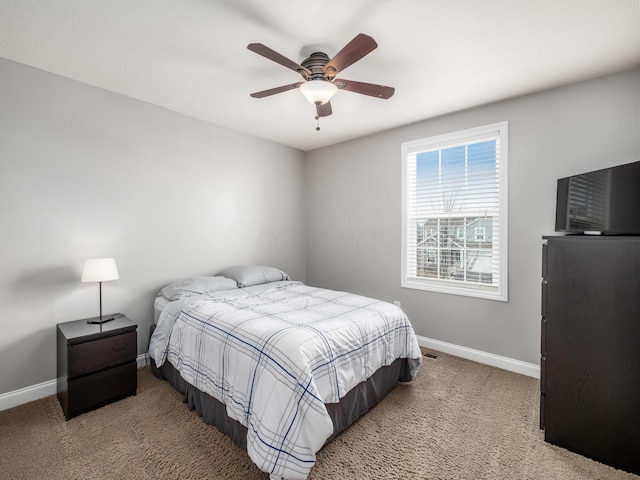 bedroom featuring baseboards, ceiling fan, and light colored carpet