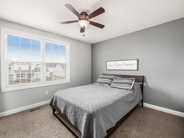 bedroom featuring ceiling fan, carpet floors, visible vents, and baseboards