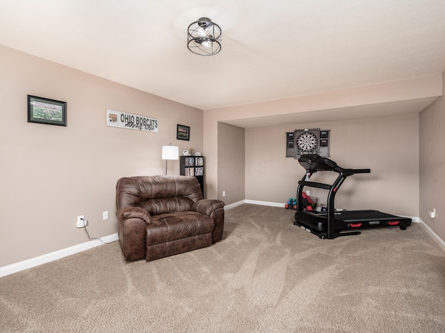 exercise area featuring carpet flooring and baseboards