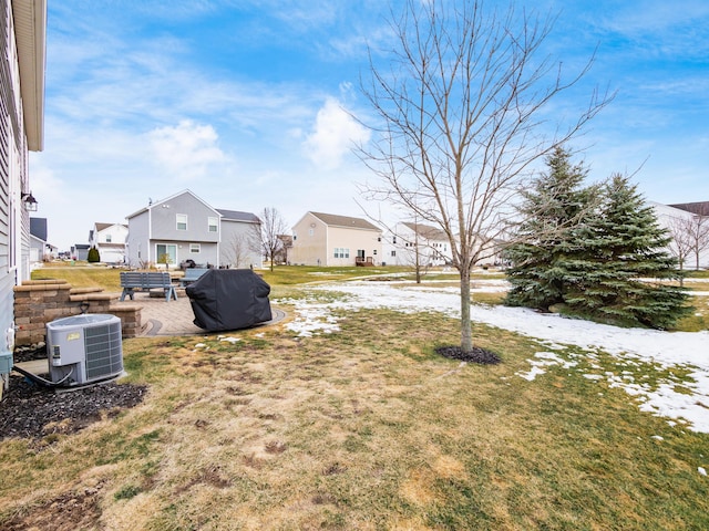 view of yard with a patio, cooling unit, and a residential view