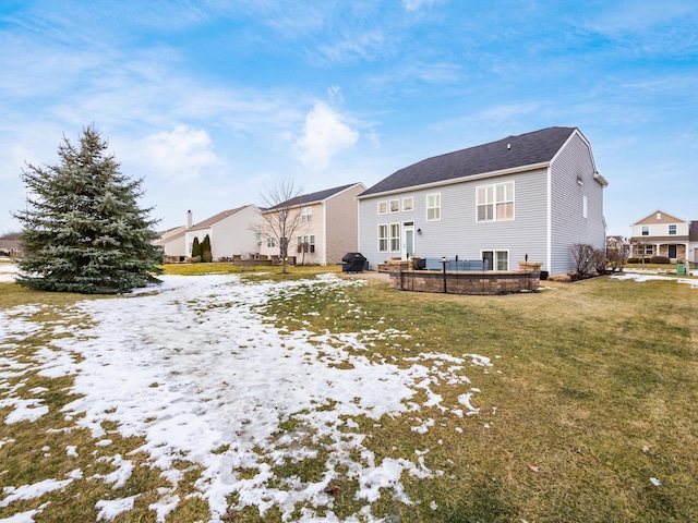 snow covered property with a yard and a residential view