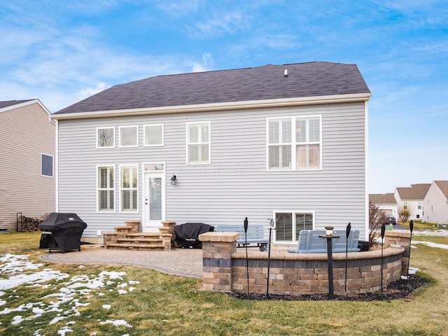 back of property featuring a yard, entry steps, a patio, and a shingled roof