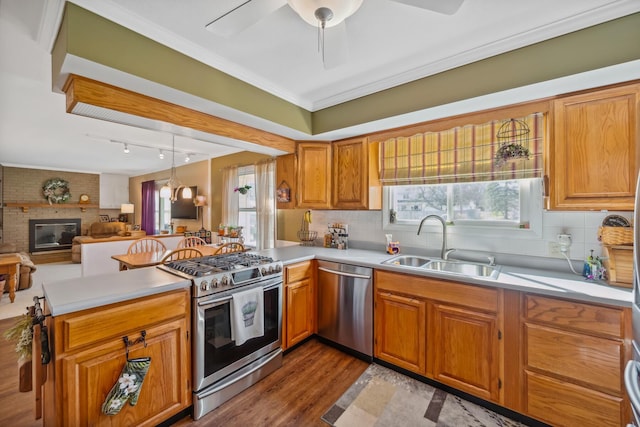 1259 Timber Ln, Marion, OH 43302 - kitchen featuring light countertops, a peninsula, appliances with stainless steel finishes, a sink, and backsplash