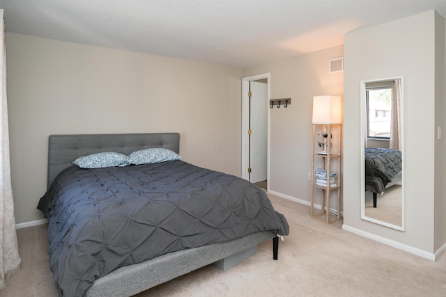 bedroom with baseboards, carpet flooring, and visible vents