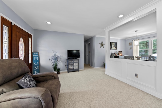 living area featuring recessed lighting, baseboards, crown molding, and light colored carpet