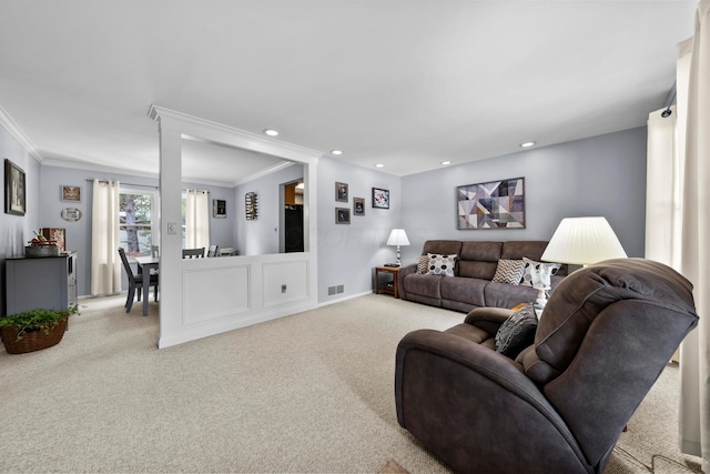 living area featuring recessed lighting, visible vents, crown molding, and light colored carpet