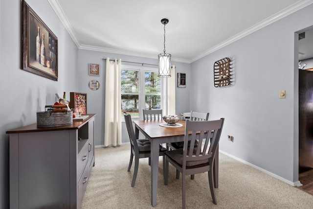 dining room with ornamental molding, light colored carpet, and baseboards